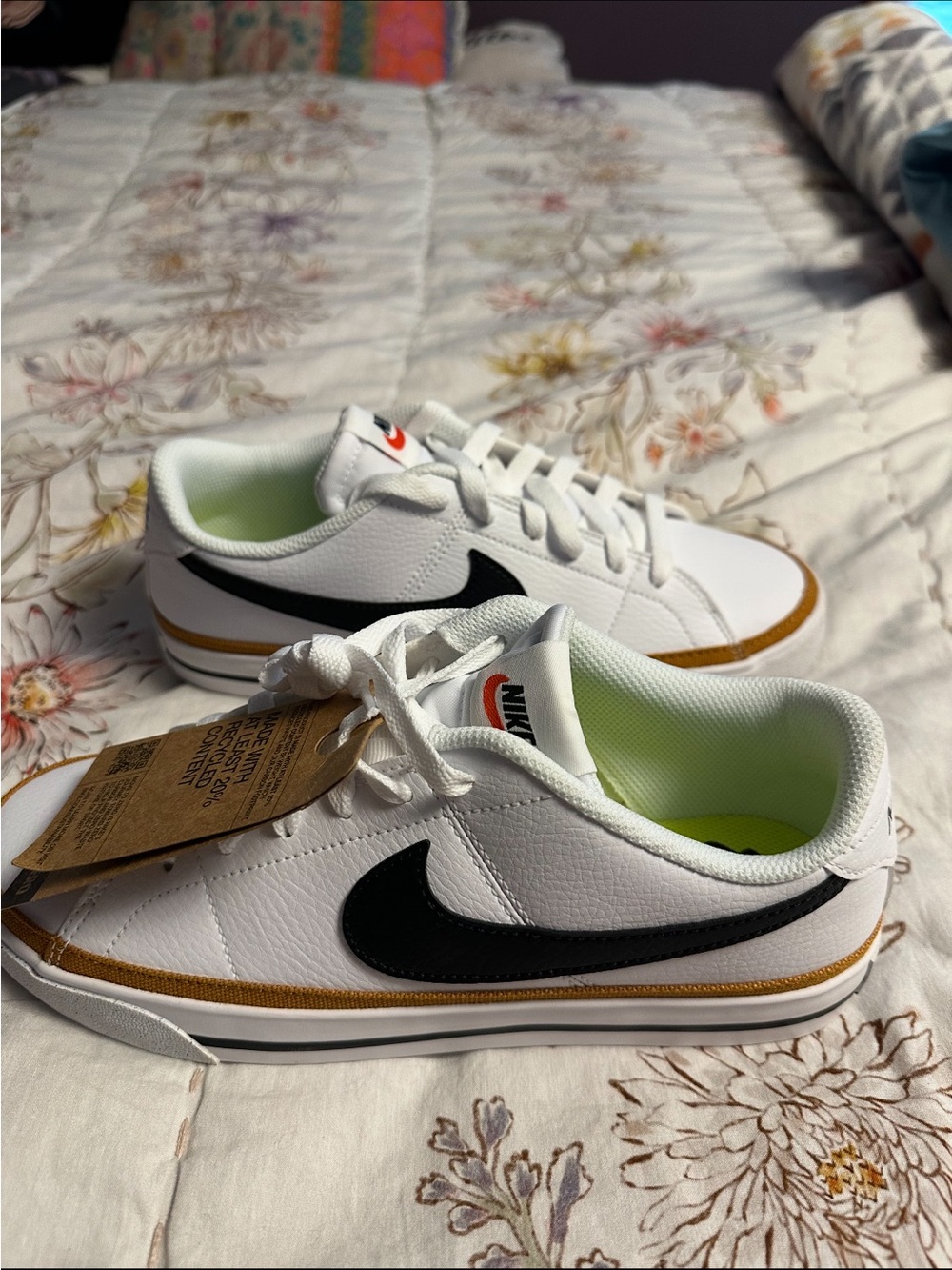 Nike White Athletic Sneakers with Black Swoosh and Gold Trim